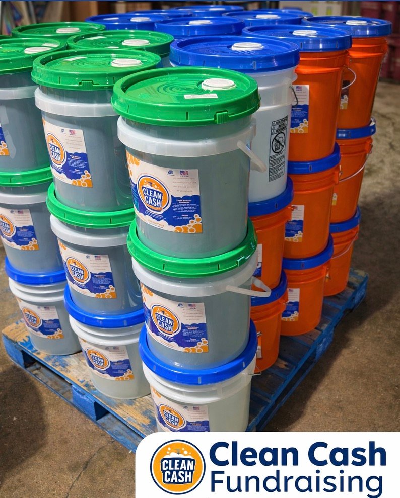 Clean Cash detergent buckets stacked on pallet